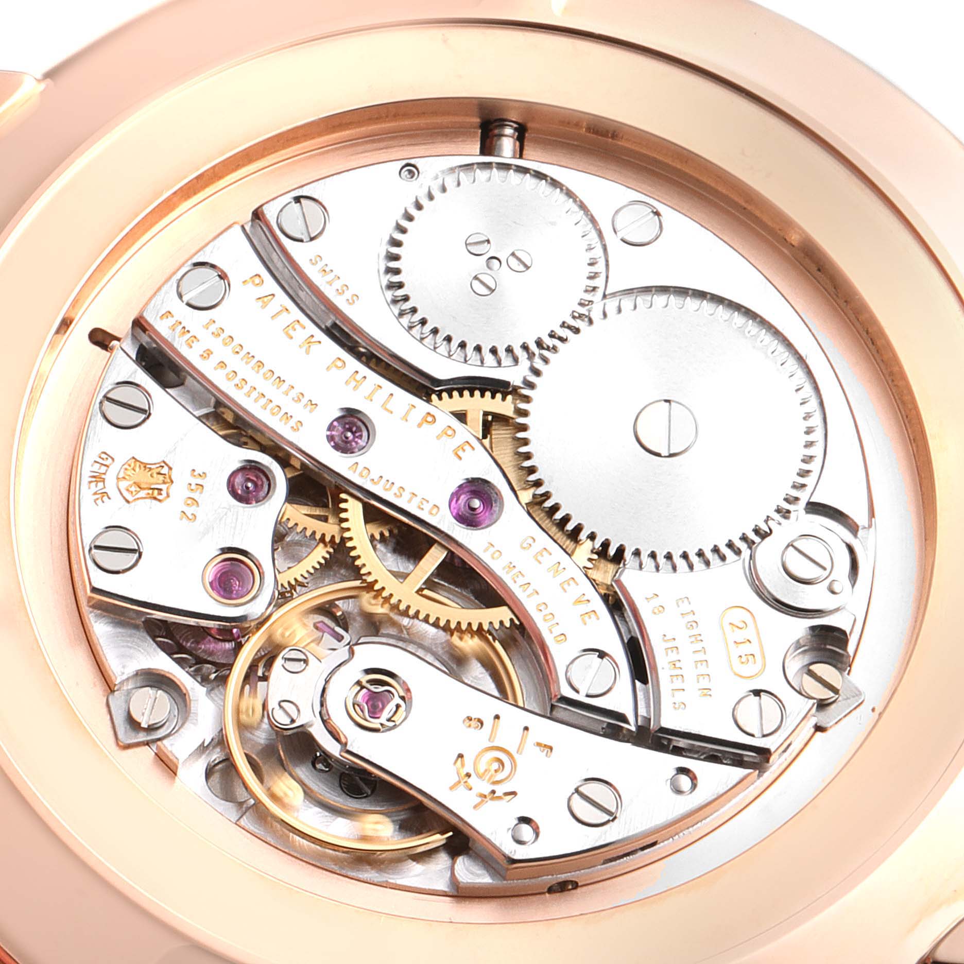 The image shows the inner mechanical movement of a Patek Philippe Calatrava 5119R Men
s Rose Gold White Dial 5119R Men
s Rose Gold White Dial watch from a close-up, rear-view angle.