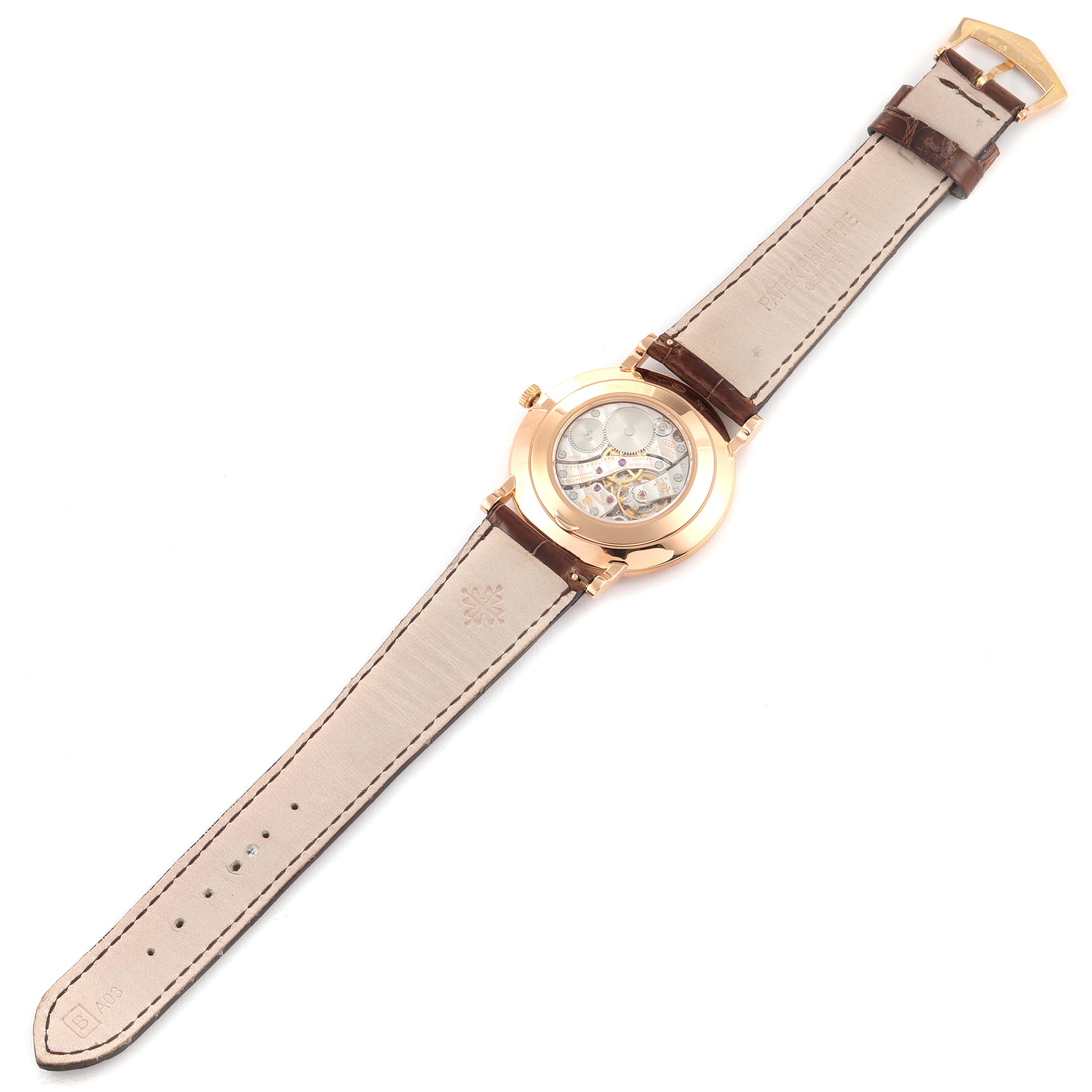 This is a rear view of a Patek Philippe Calatrava 5119R Men
s Rose Gold White Dial 5119R Men
s Rose Gold White Dial watch showing the movement and leather strap.