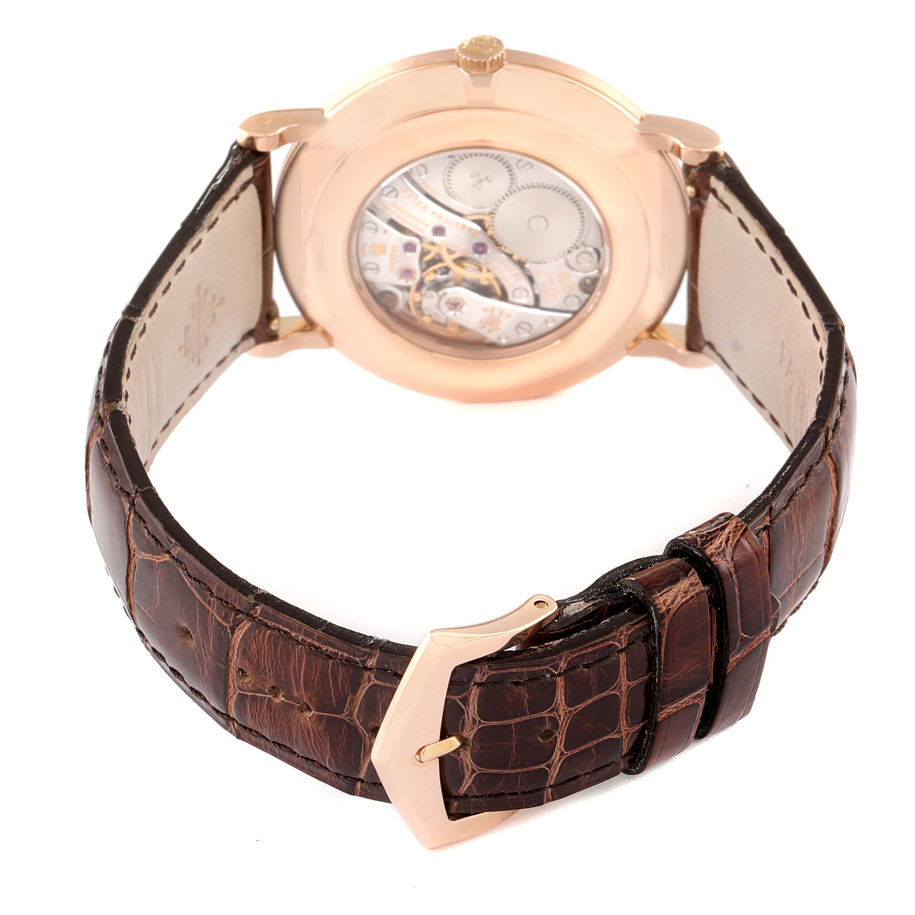 This image shows the back view of a Patek Philippe Calatrava 5119R Men
s Rose Gold White Dial 5119R Men
s Rose Gold White Dial watch, highlighting its transparent case back and leather strap.