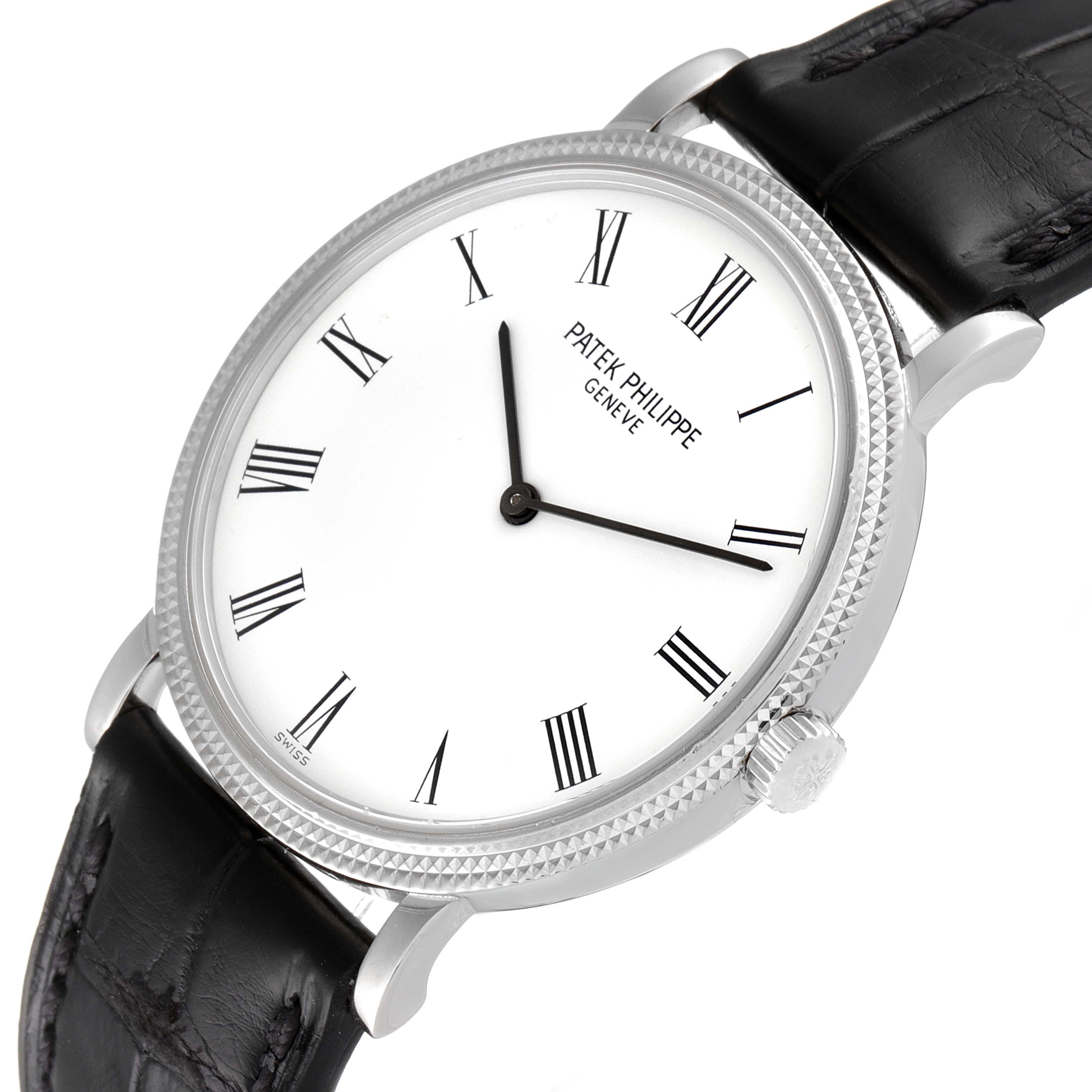 The image shows a Patek Philippe Calatrava 5120G Men
s White Gold White Dial 5120G Men
s White Gold White Dial watch from an angled perspective, highlighting the dial, bezel, crown, and part of the black strap.
