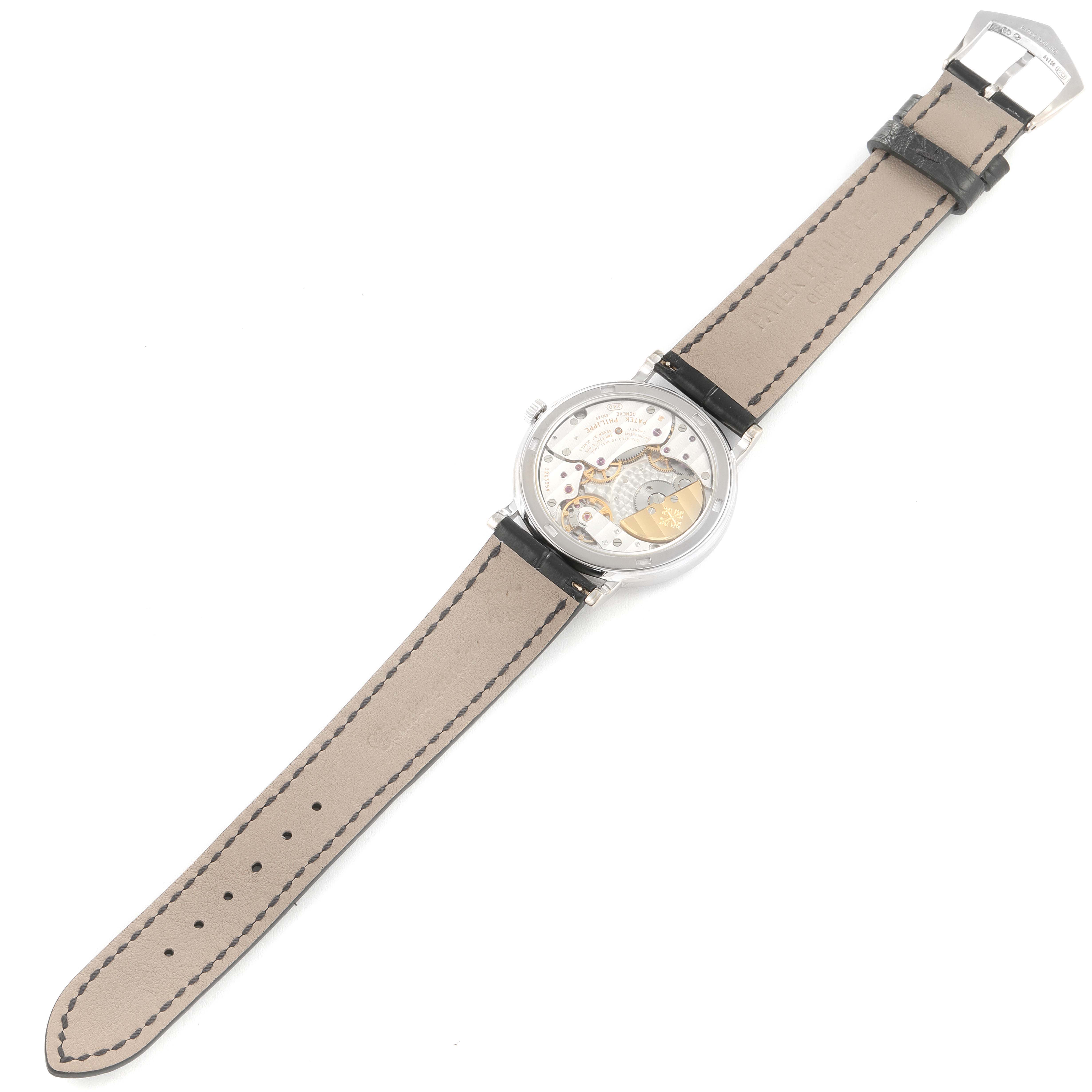 The image shows the back of a Patek Philippe Calatrava 5120G Men
s White Gold White Dial 5120G Men
s White Gold White Dial watch, displaying the movement and full beige strap.