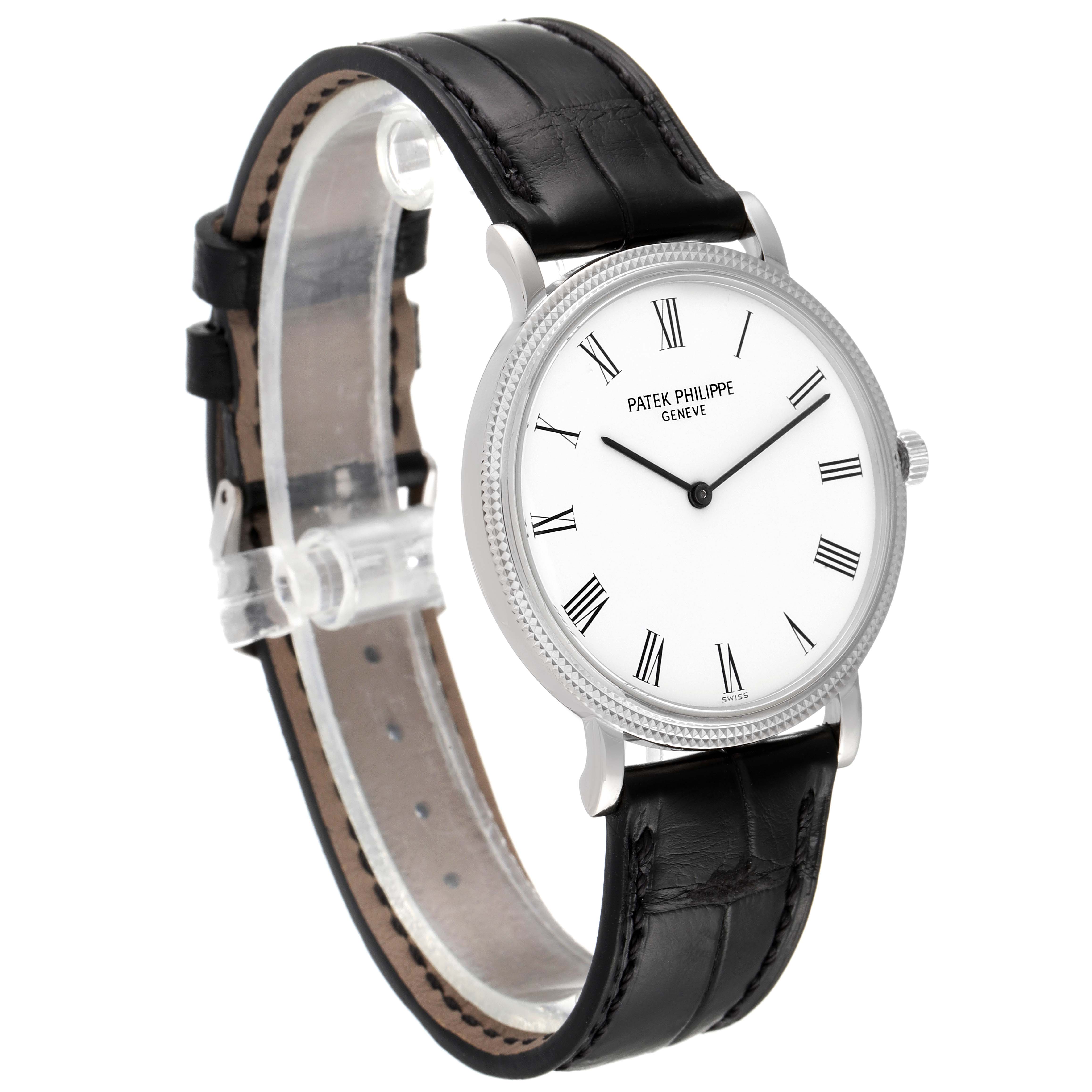 The image shows a Patek Philippe Calatrava 5120G Men
s White Gold White Dial 5120G Men
s White Gold White Dial watch, featuring a clear view of its face, bezel, and black leather strap from a slightly angled side view.
