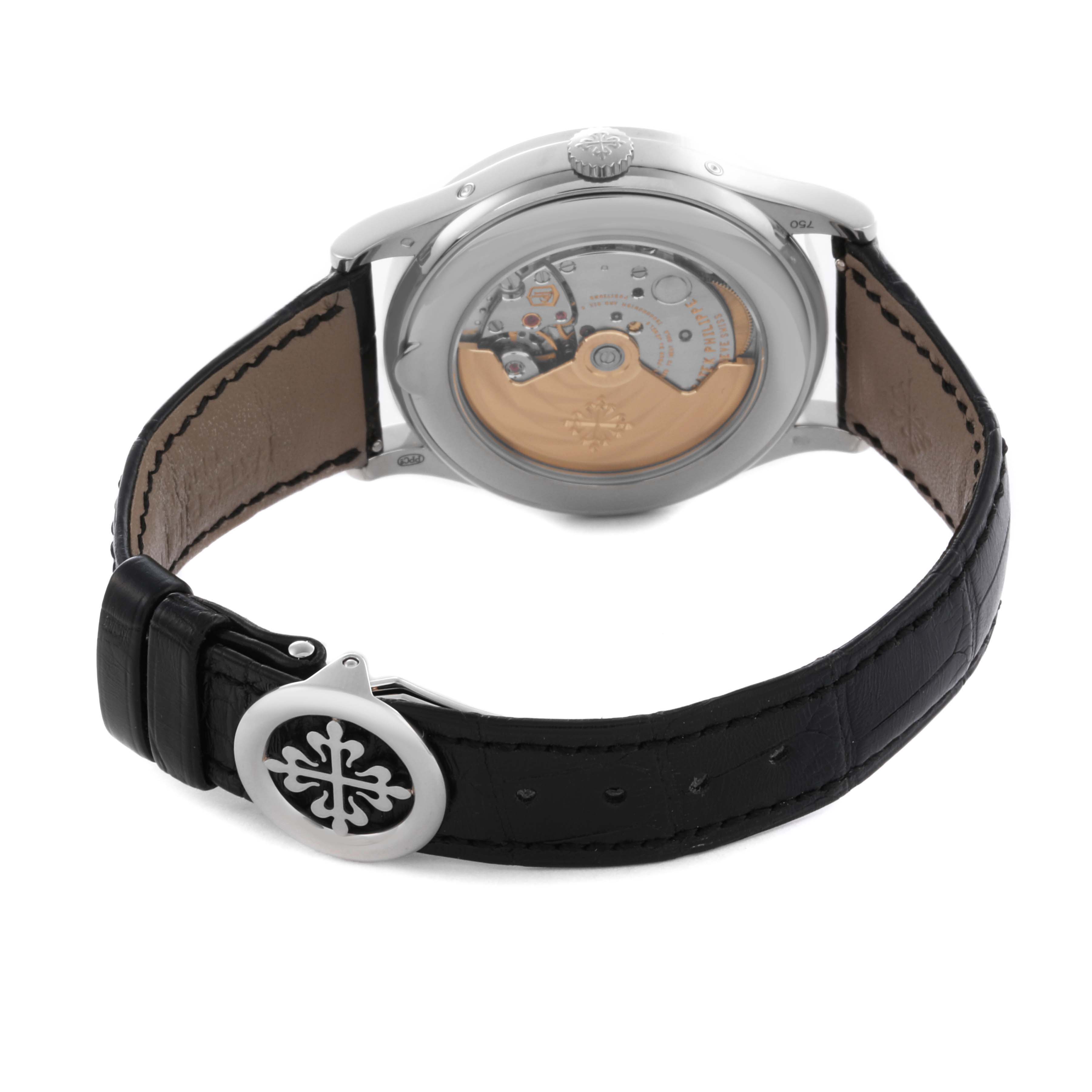 The Patek Philippe Complications 5396G-014 Men's White Gold Grey Dial 5396G-014 Men's White Gold Grey Dial watch is shown from the back, displaying the movement and leather strap with a branded clasp.