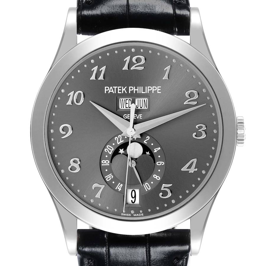 The Patek Philippe Complications watch is shown from the front, highlighting its face, numerals, hands, and leather strap.