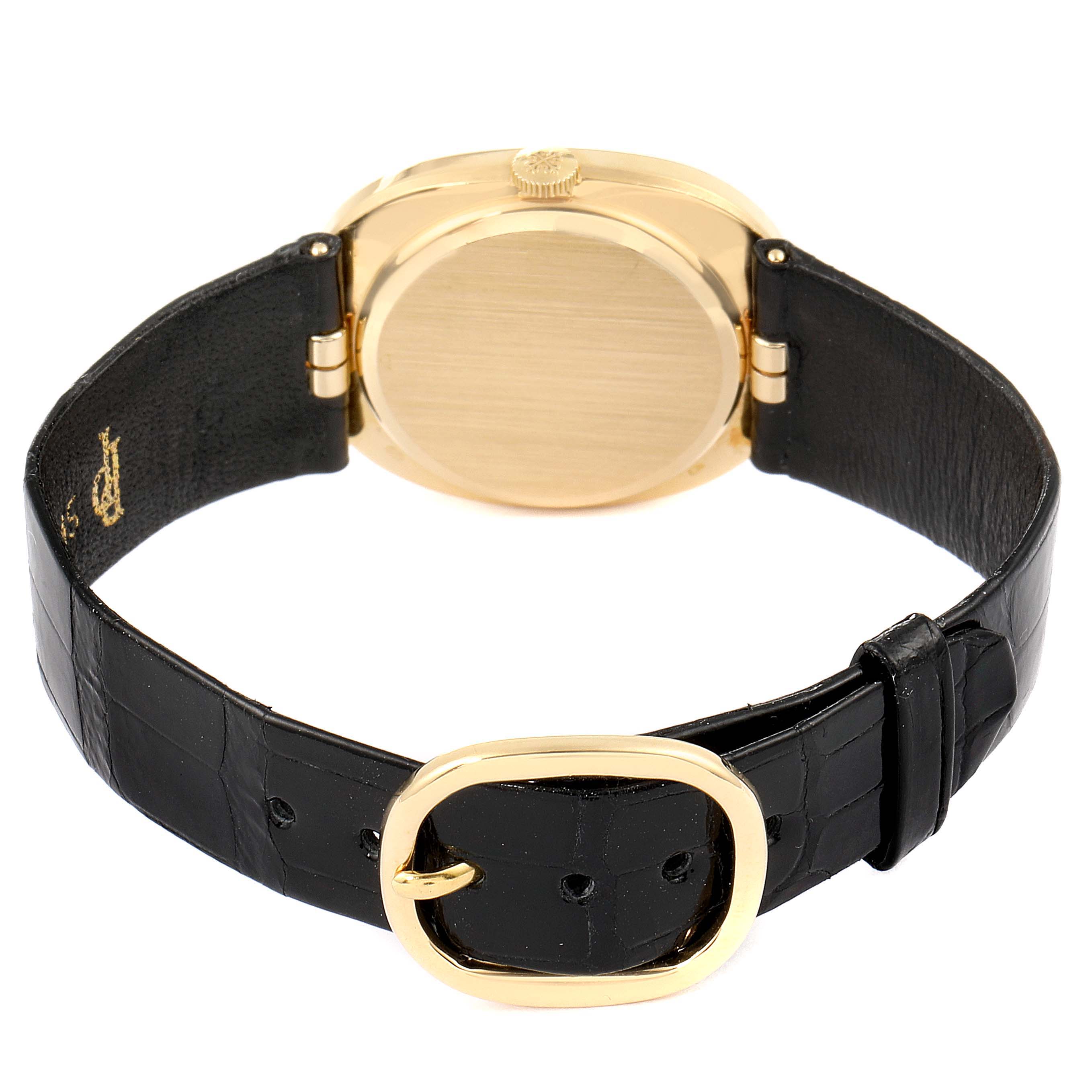 The image shows the back view of the Patek Philippe Golden Ellipse 3948 Men's Yellow Gold White Dial 3948 Men's Yellow Gold White Dial watch with its black strap and gold buckle.