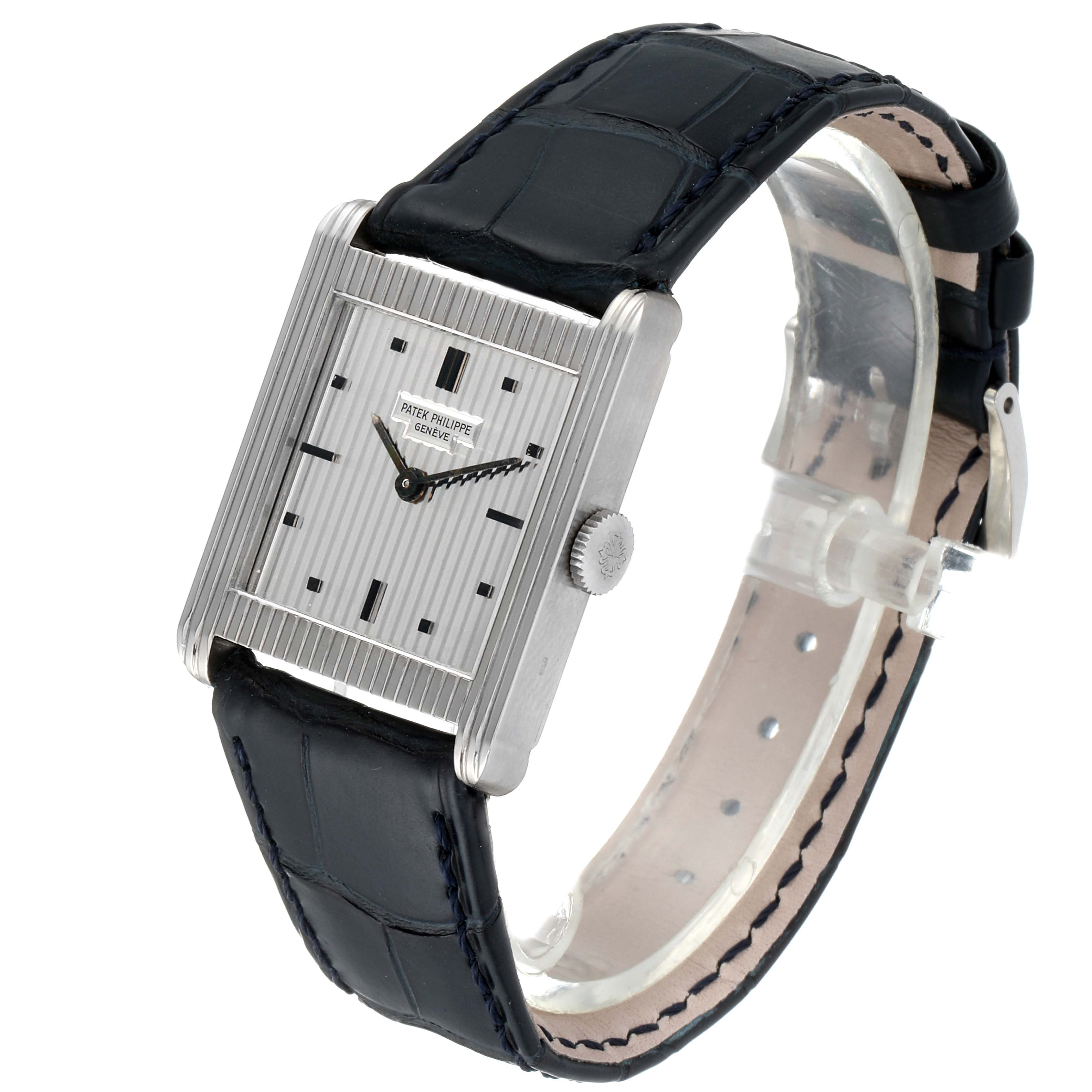 The image shows a side view of the Patek Philippe Vintage 3467 Men's White Gold Silver Dial 3467 Men's White Gold Silver Dial watch, highlighting its rectangular dial, crown, and black leather strap.