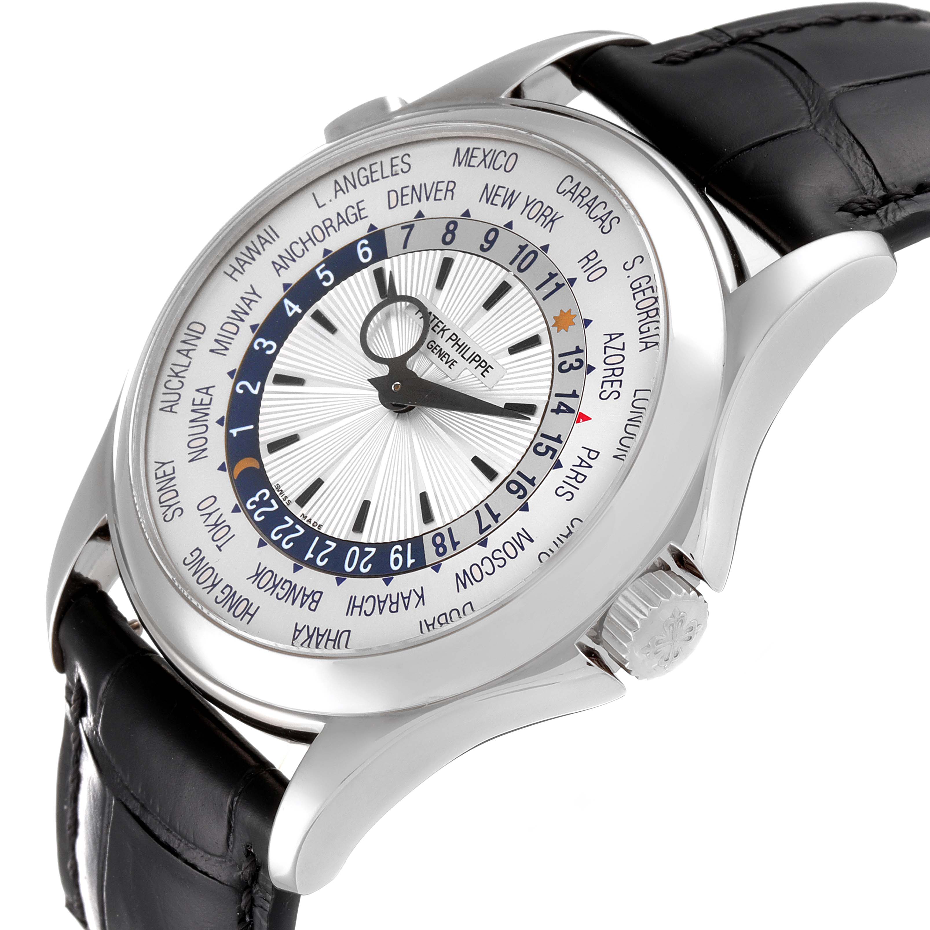 The image shows a close-up, angled view of the Patek Philippe Complications 5130G-019 Men's Stainless Steel Silver Dial 5130G-019 Men's Stainless Steel Silver Dial watch, highlighting its dial, world time zones, and leather strap.