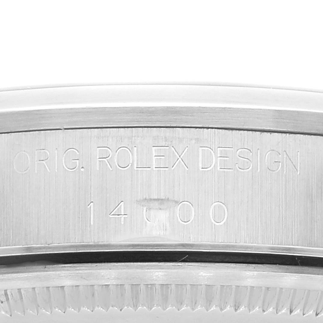 This image shows a close-up of the side of a Rolex Air-King 14000 Men's Stainless Steel Pink Dial 14000 Men's Stainless Steel Pink Dial watch, displaying the model number and "ORIG. ROLEX DESIGN" engraving.
