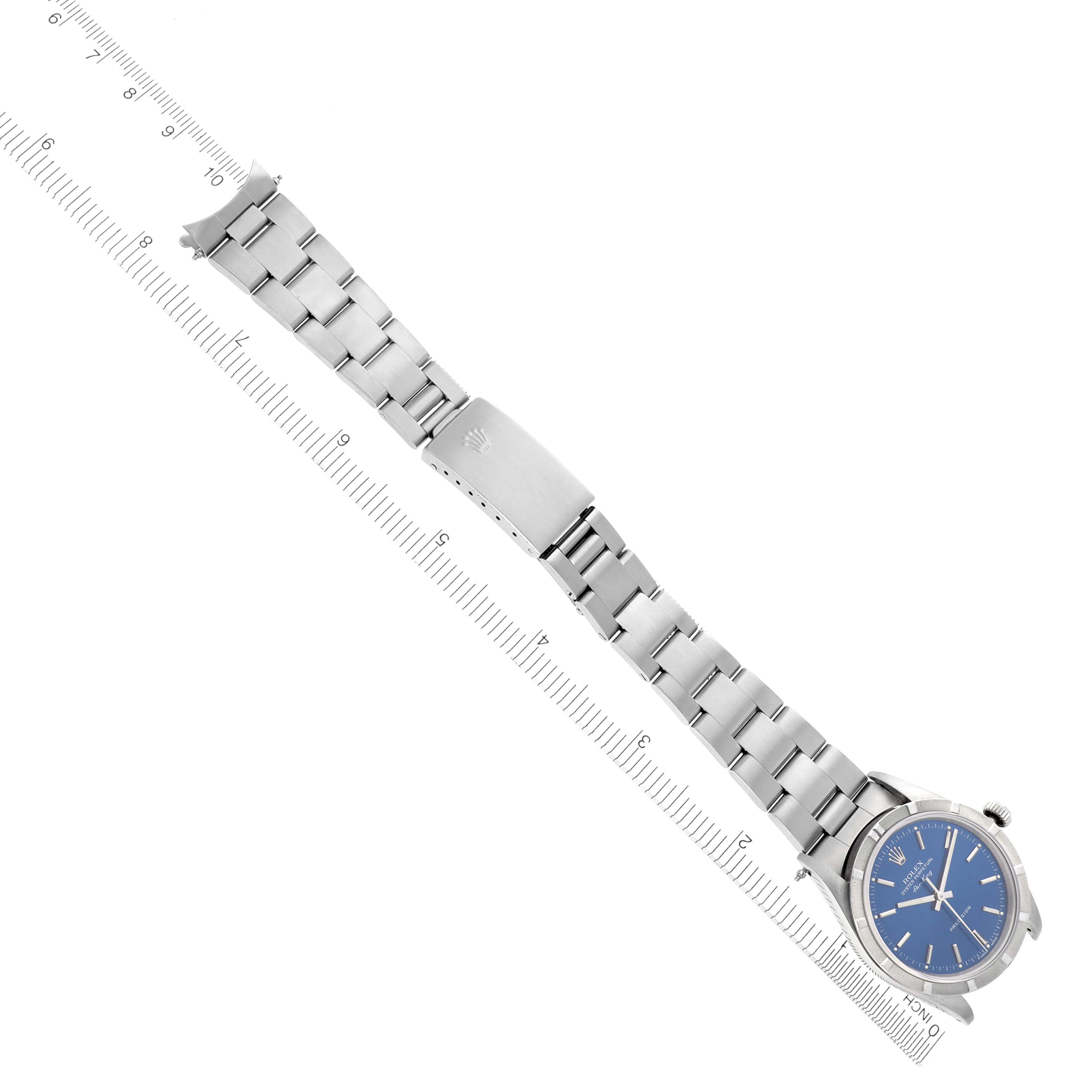 The Rolex Air-King 14010 Men's Stainless Steel Blue Dial 14010 Men's Stainless Steel Blue Dial watch is shown at an angle, displaying the full bracelet and clasp alongside a ruler for size reference.