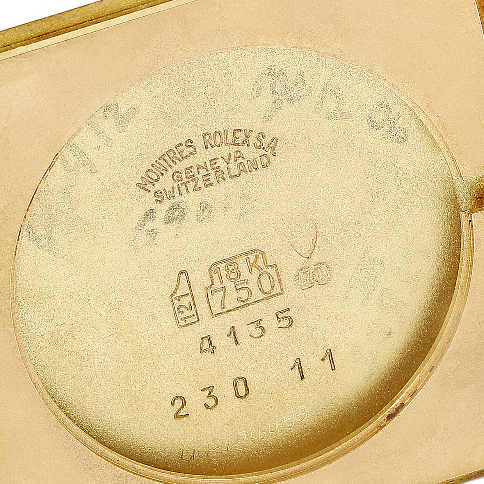 The image shows the inner case back of a Rolex Cellini 4135 Men's Yellow Gold Champagne Dial 4135 Men's Yellow Gold Champagne Dial watch featuring engravings and hallmarks.