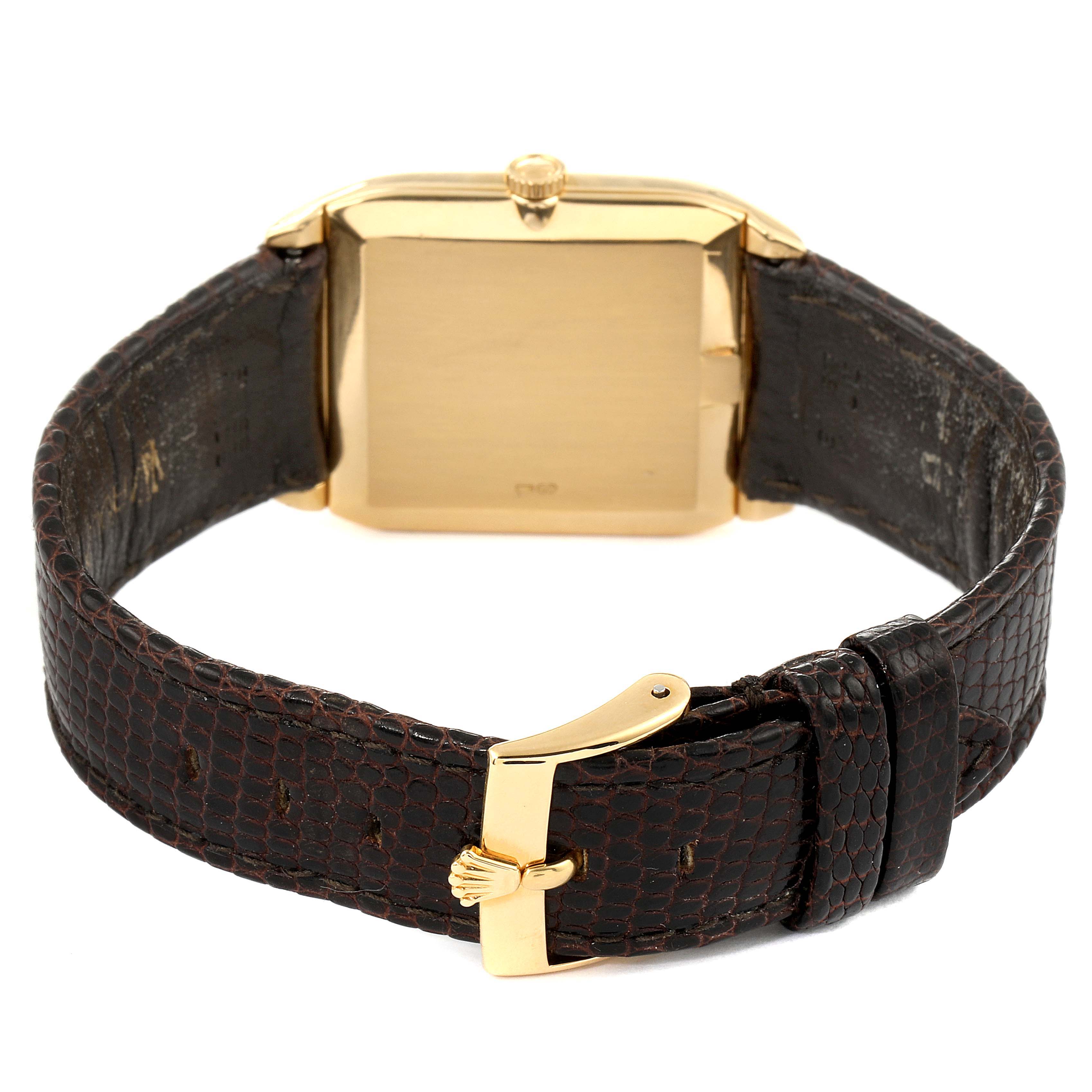 The image shows the back view of a Rolex Cellini 4135 Men's Yellow Gold Champagne Dial 4135 Men's Yellow Gold Champagne Dial watch, featuring its gold case and leather strap with a gold buckle.