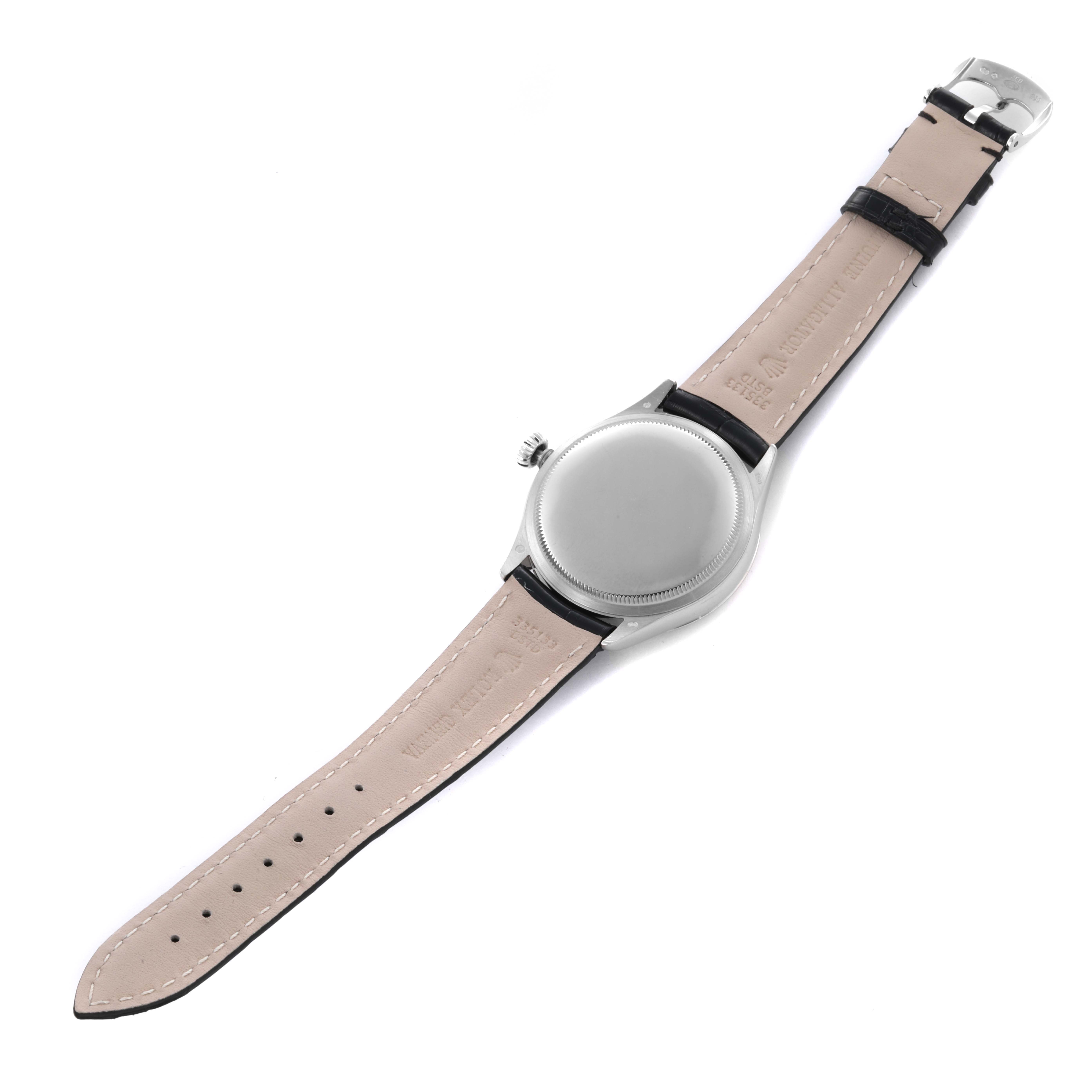 The Rolex Cellini 50509 Men's White Gold White Dial 50509 Men's White Gold White Dial watch is shown from the back, displaying the case and leather strap with the buckle side visible.