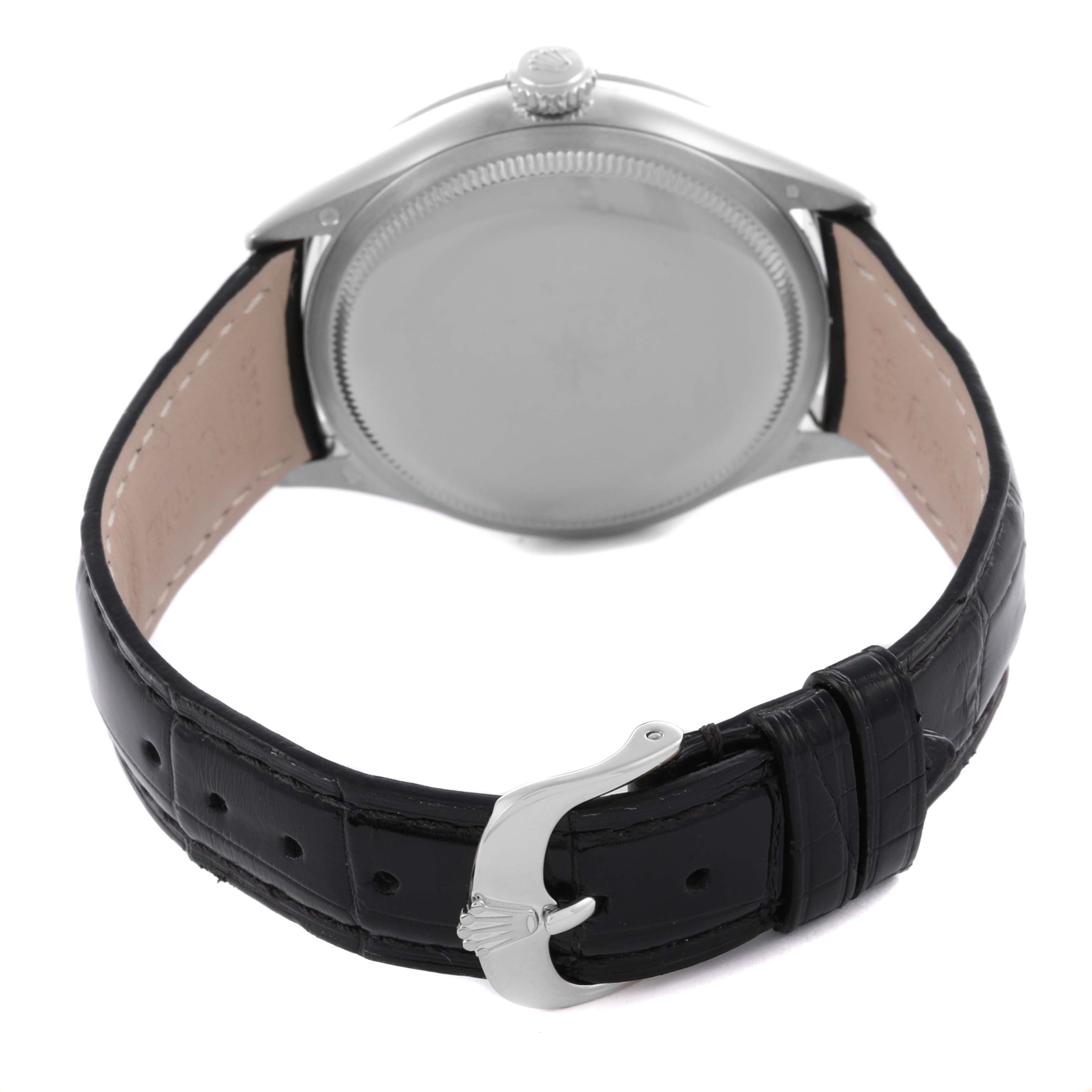 The Rolex Cellini 50509 Men's White Gold White Dial 50509 Men's White Gold White Dial watch is shown from the back, highlighting the case, crown, and leather strap with a clasp.