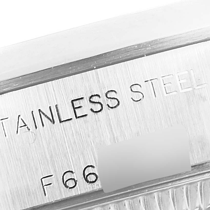 This close-up shows the side engraving on the bezel of a Rolex Date 79160 Women
s Stainless Steel Pink Dial 79160 Women
s Stainless Steel Pink Dial model, featuring "STAINLESS STEEL" text.