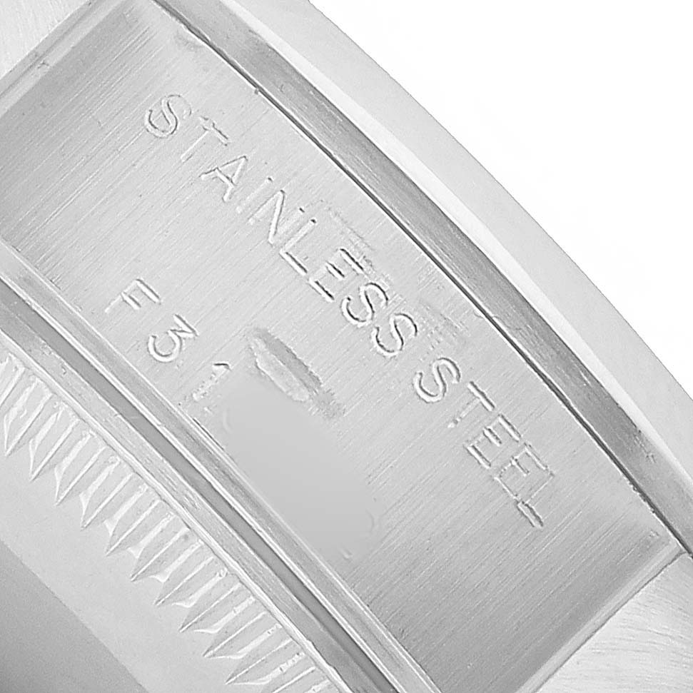 The image shows an engraved stainless steel detail of the Rolex Date 79160 Women's Stainless Steel Pink Dial model, focusing on part of the case back.