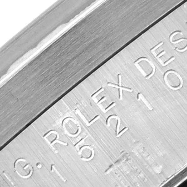 The image shows a close-up angle of the engraved inner case of a Rolex Date 15210 Men's Stainless Steel Blue Dial 15210 Men's Stainless Steel Blue Dial watch.