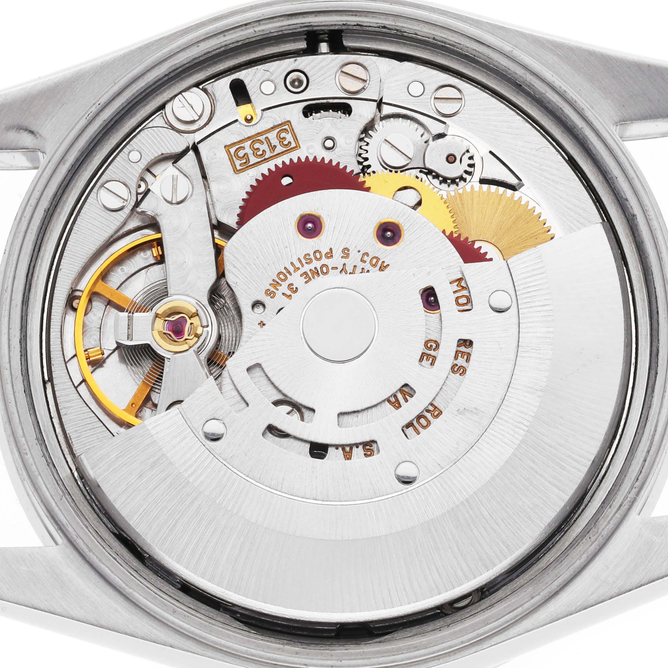 The image shows the back of a Rolex Date 15210 Men's Stainless Steel Silver Dial model, highlighting its movement and intricate internal mechanism.