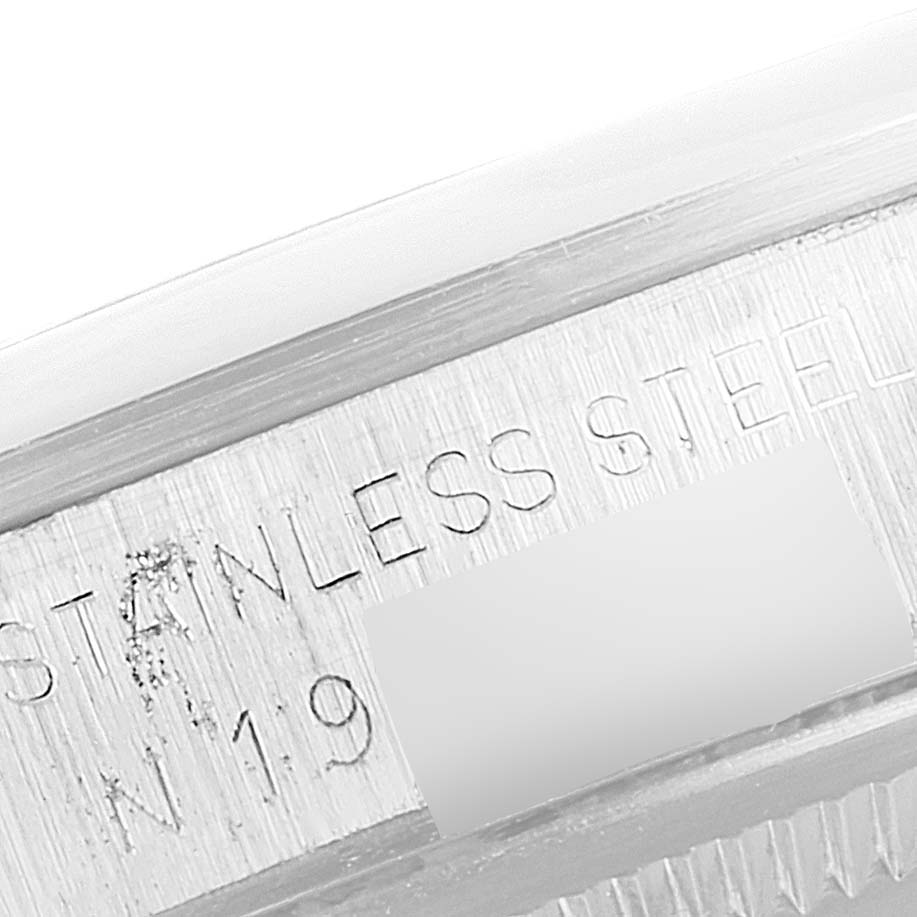 The image shows a close-up of the stainless steel case band of the Rolex Date 15200 Men's Stainless Steel Silver Dial 15200 Men's Stainless Steel Silver Dial model, displaying its engraved text.