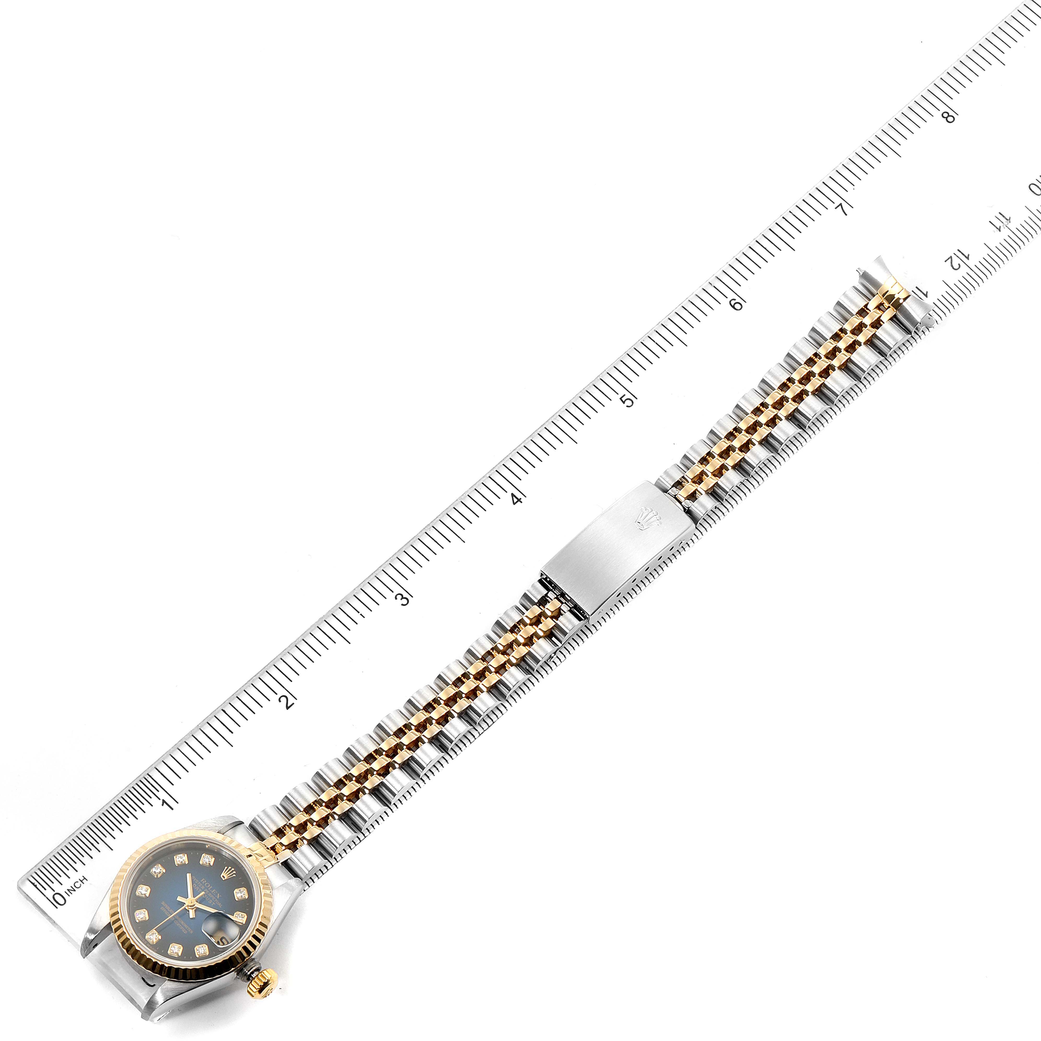 The image shows a top-down view of a Rolex Datejust 69173 Women's Steel and Gold (two tone) Blue Dial 69173 Women's Steel and Gold (two tone) Blue Dial watch, displaying its face, bezel, and bracelet alongside a ruler.