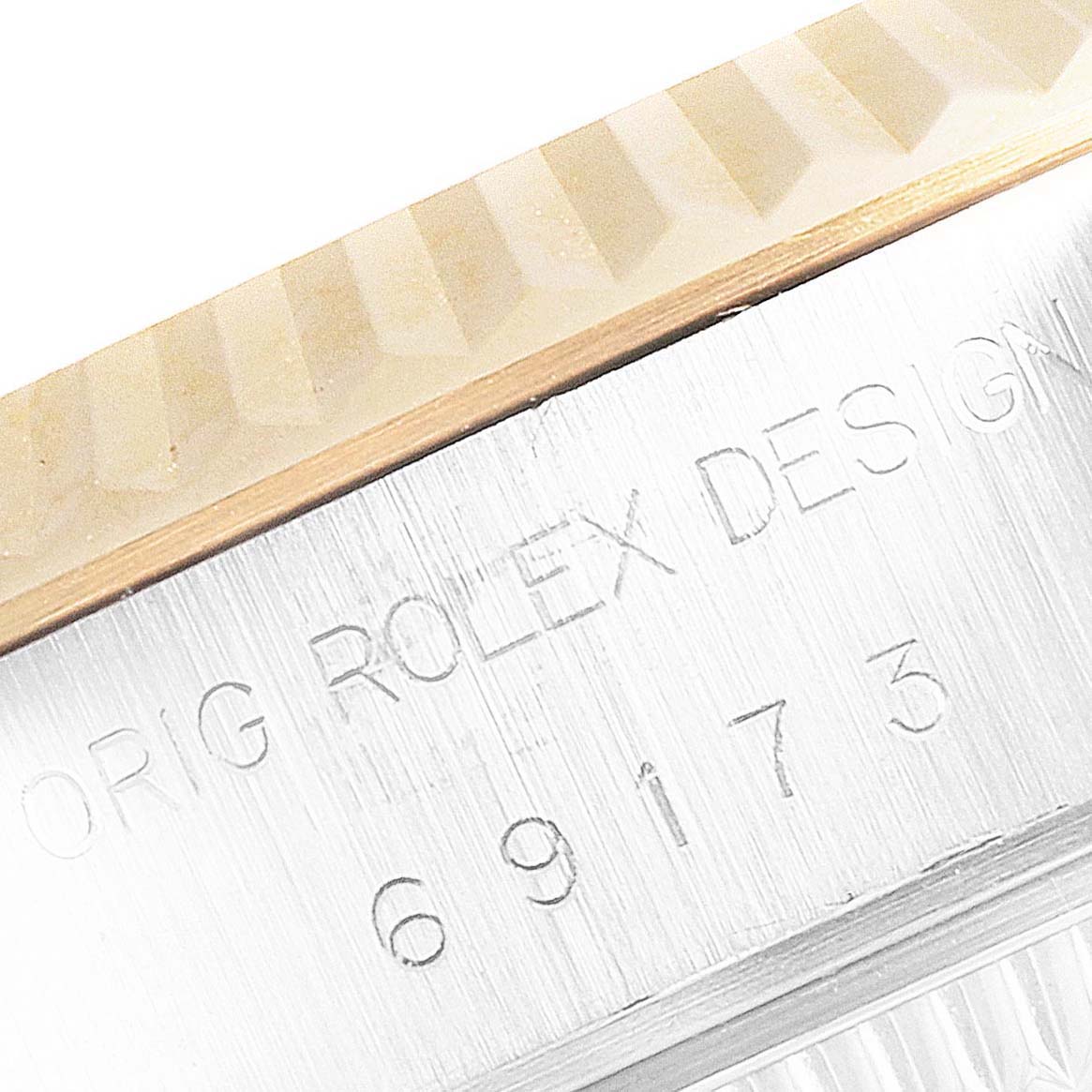 This close-up image shows the engraved side of the bezel and case of the Rolex Datejust 69173 Women's Steel and Gold (two tone) Blue Dial 69173 Women's Steel and Gold (two tone) Blue Dial model 69173.