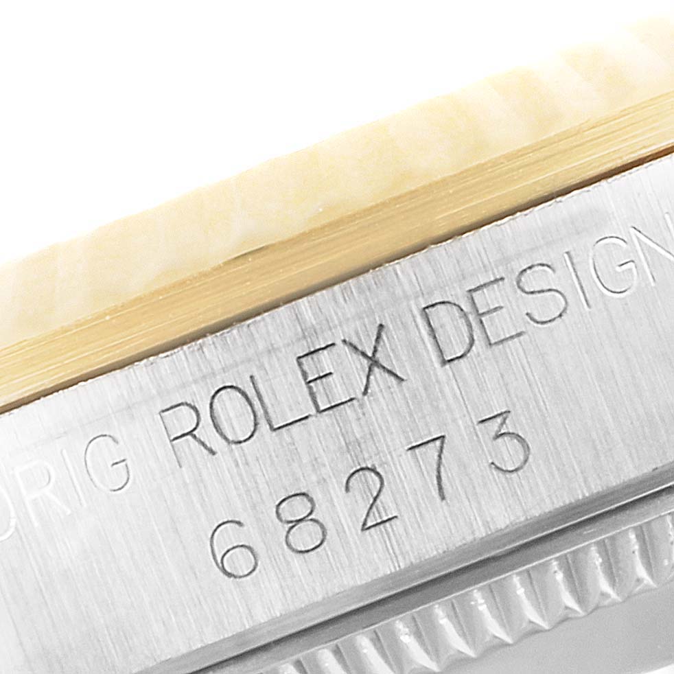 The image shows a close-up of the engraved model number and bezel of a Rolex Datejust 68273 Women
s Steel and Gold (two tone) White Dial 68273 Women
s Steel and Gold (two tone) White Dial watch.