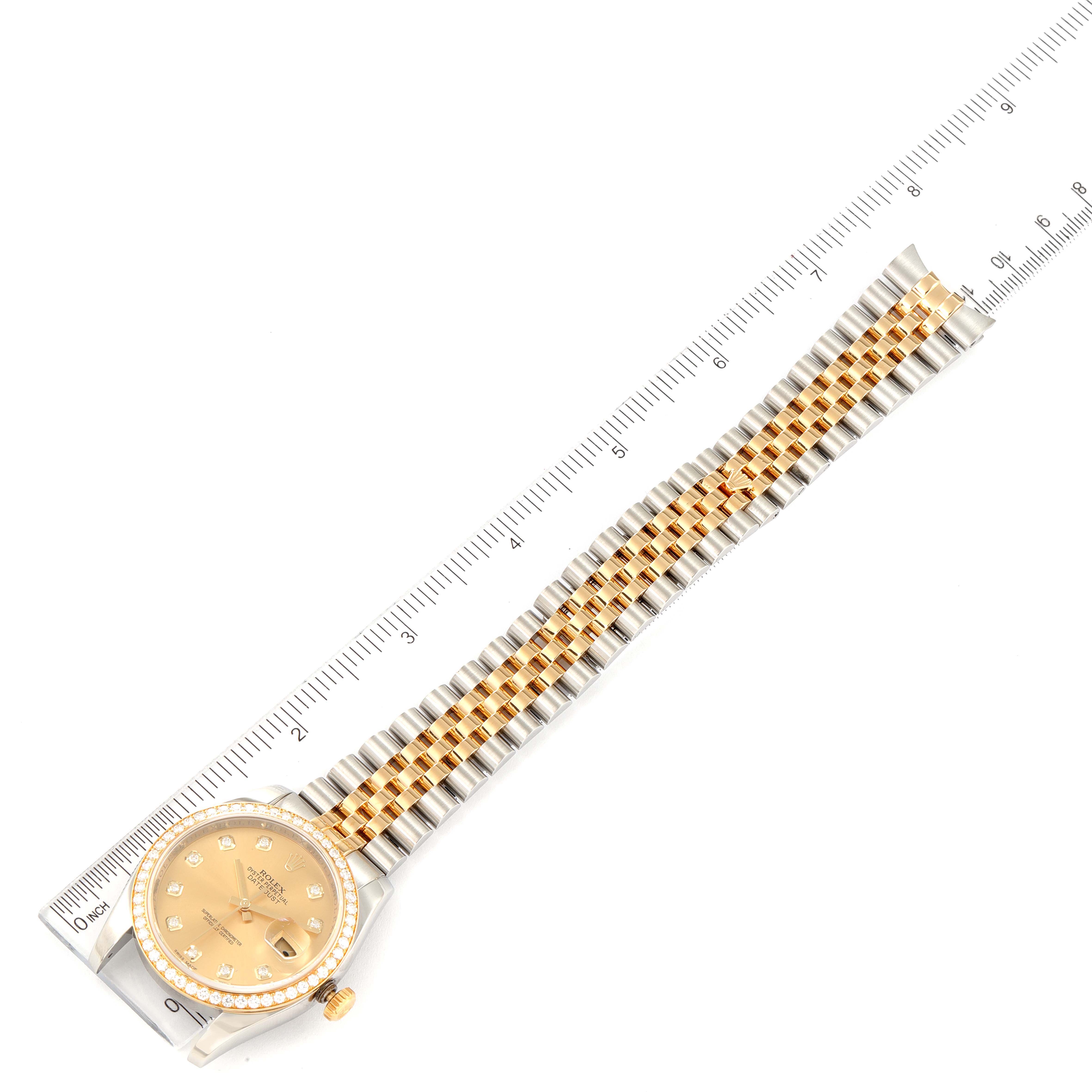 The image shows a Rolex Datejust 116243 Men's Steel and Gold (two tone) Champagne Dial 116243 Men's Steel and Gold (two tone) Champagne Dial watch laid flat, displaying its face, bezel, and band beside a ruler.
