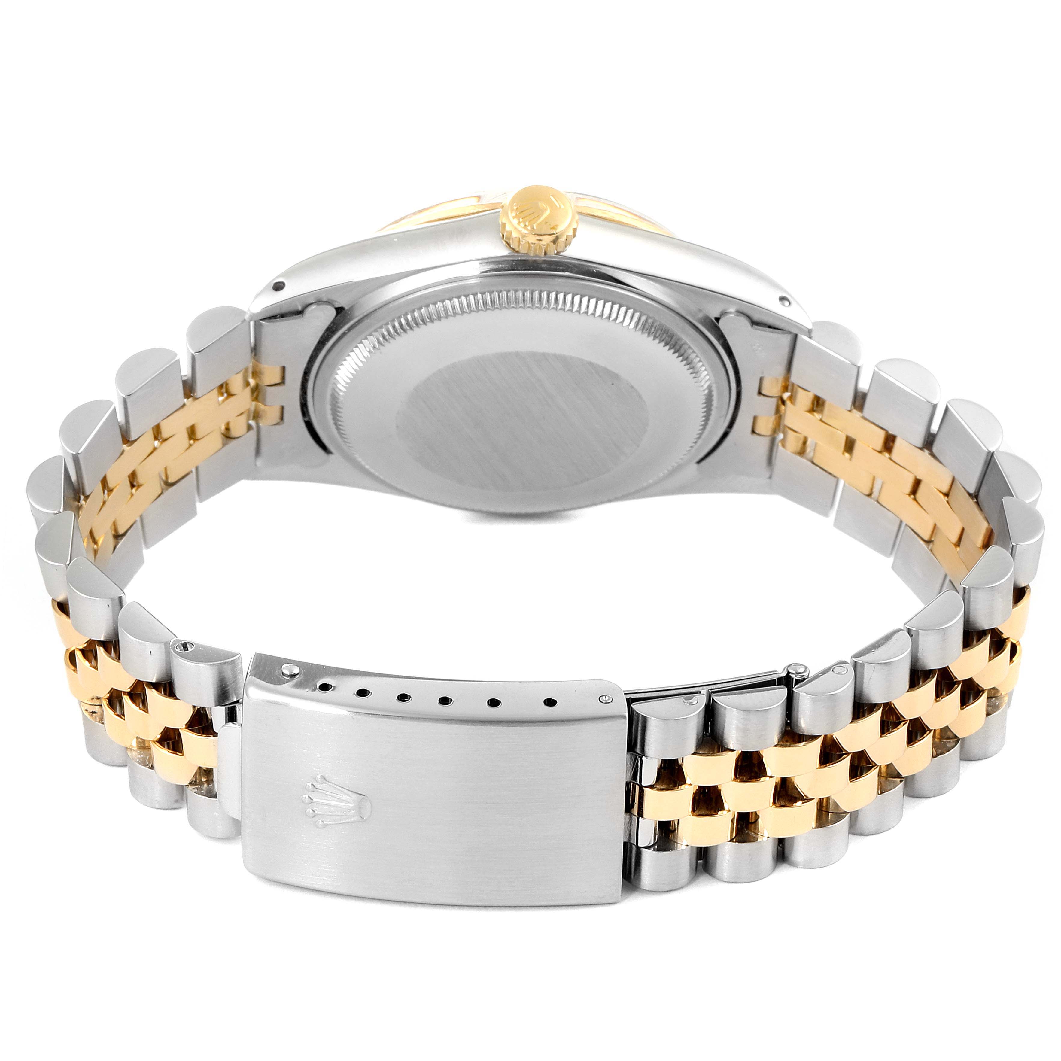 The image shows the back view of a Rolex Datejust 16013 Men
s Steel and Gold (two tone) Champagne Dial 16013 Men
s Steel and Gold (two tone) Champagne Dial watch, displaying its case back, crown, and two-tone Jubilee bracelet with a clasp.