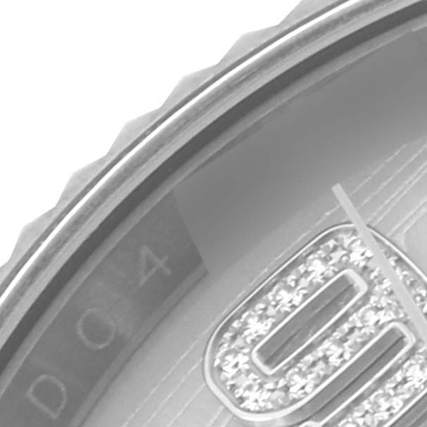 The image shows a close-up of the bezel and part of the dial of a Rolex Datejust 116139 Men's White Gold Silver Dial 116139 Men's White Gold Silver Dial watch.