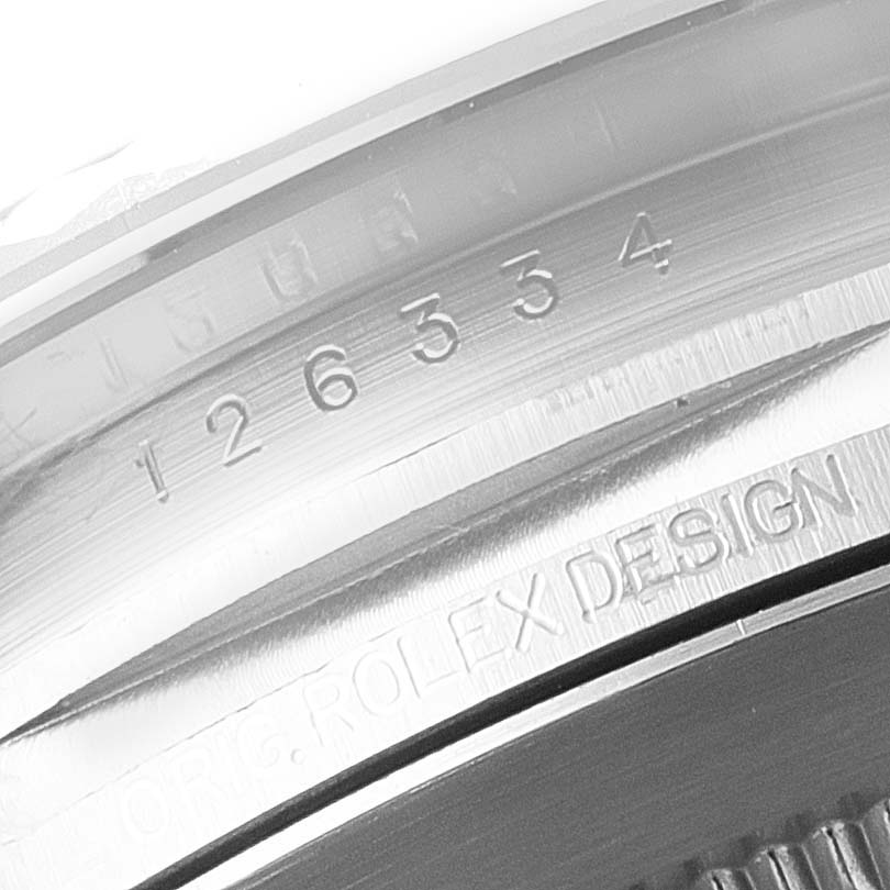 This close-up image shows the engraved serial number and "ROLEX DESIGN" text on the inner bezel of a Rolex Datejust 41 126334 Men's Stainless Steel Grey Dial 126334 Men's Stainless Steel Grey Dial watch.