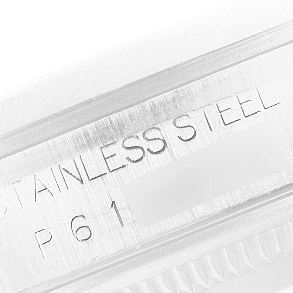 This image shows a close-up of the engraved text "STAINLESS STEEL" on the case of a Rolex Datejust 16200 Men
s Stainless Steel Blue Dial 16200 Men
s Stainless Steel Blue Dial watch.