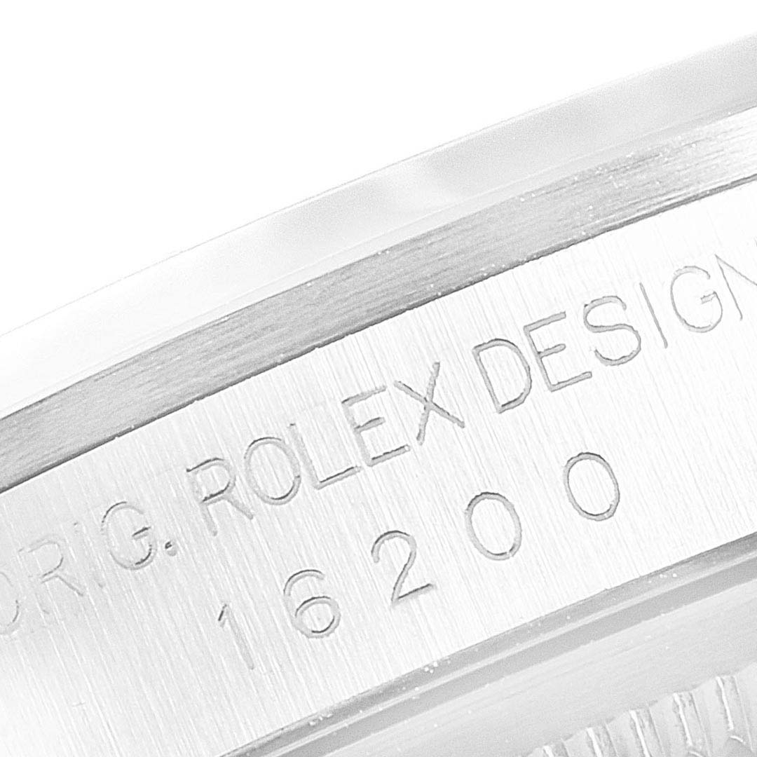 This close-up image shows the engraved serial and model number on the side of the bezel of a Rolex Datejust 16200 Men
s Stainless Steel Blue Dial 16200 Men
s Stainless Steel Blue Dial watch.