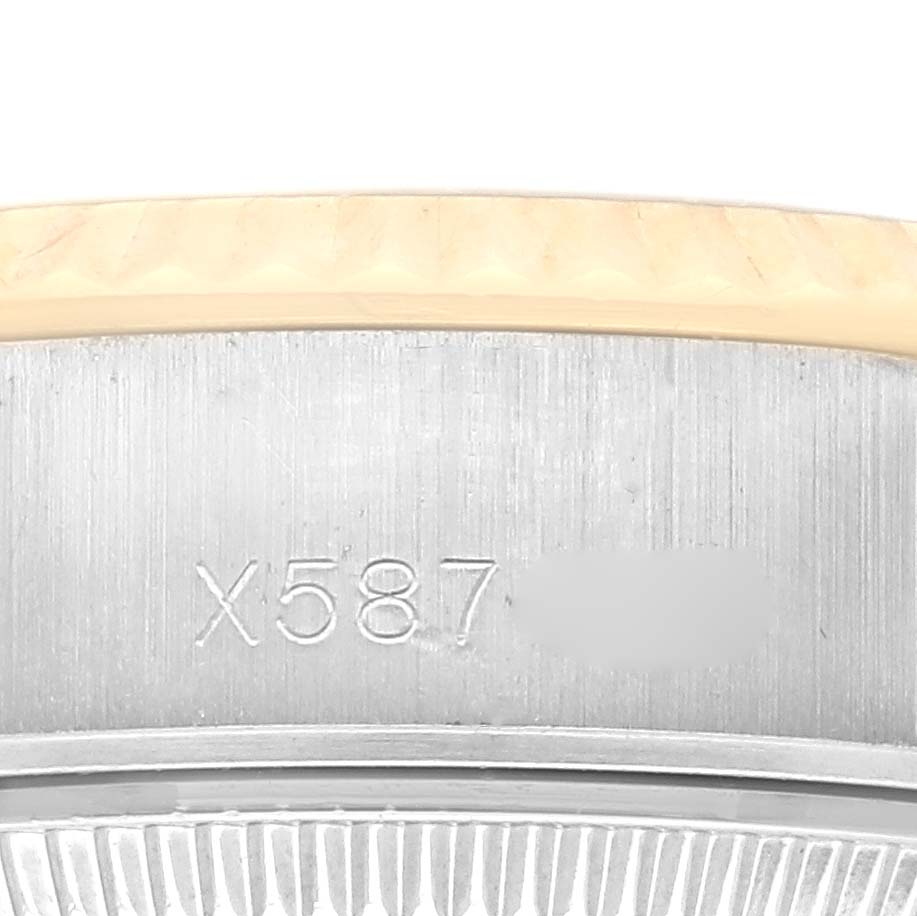 The image shows a close-up of the Rolex Datejust 69173 Women's Steel and Gold (two tone) Blue Dial 69173 Women's Steel and Gold (two tone) Blue Dial watch's side, focusing on the bezel and engraved numbers.