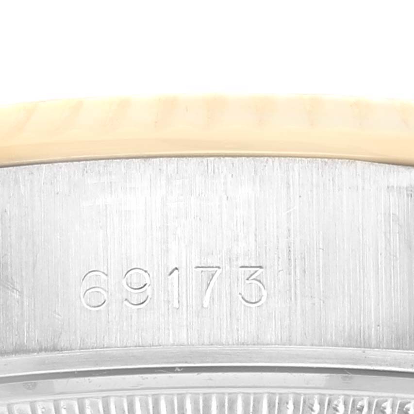 The image shows a close-up of the case edge with engraved numbers on the Rolex Datejust 69173 Women's Steel and Gold (two tone) Blue Dial 69173 Women's Steel and Gold (two tone) Blue Dial watch.