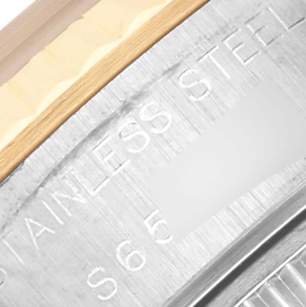 The image shows a close-up of the edge of the case back of a Rolex Datejust 69173 Women's Steel and Gold (two tone) Blue Dial 69173 Women's Steel and Gold (two tone) Blue Dial, with "STAINLESS STEEL" engraved.