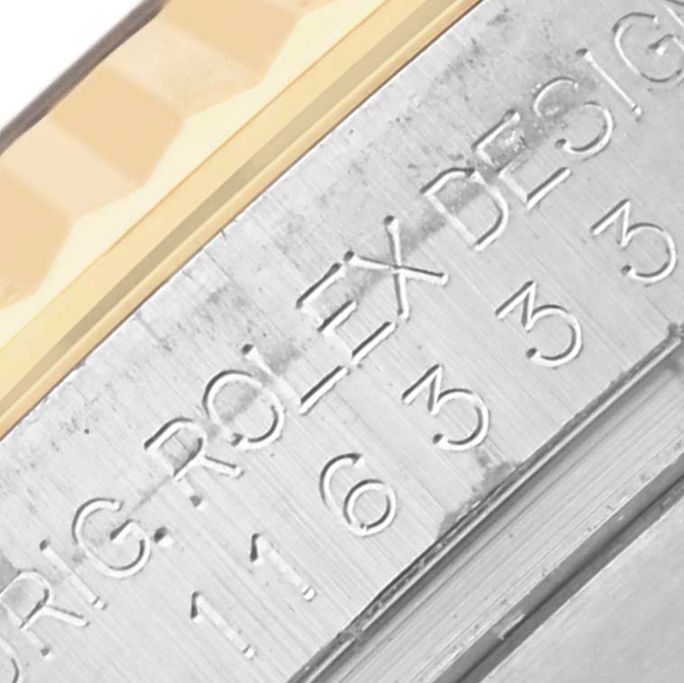 This close-up shows the engraved side of the bezel and edge of the crystal on the Rolex Datejust 41 116333 Men's Steel and Gold (two tone) Grey Dial 116333 Men's Steel and Gold (two tone) Grey Dial.