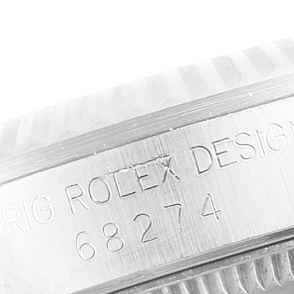 The image shows a close-up view of the case side, engraving, and partially the bezel of the Rolex Mid-Size 68274 Women
s Stainless Steel Silver Dial 68274 Women
s Stainless Steel Silver Dial model with the design number 68274.