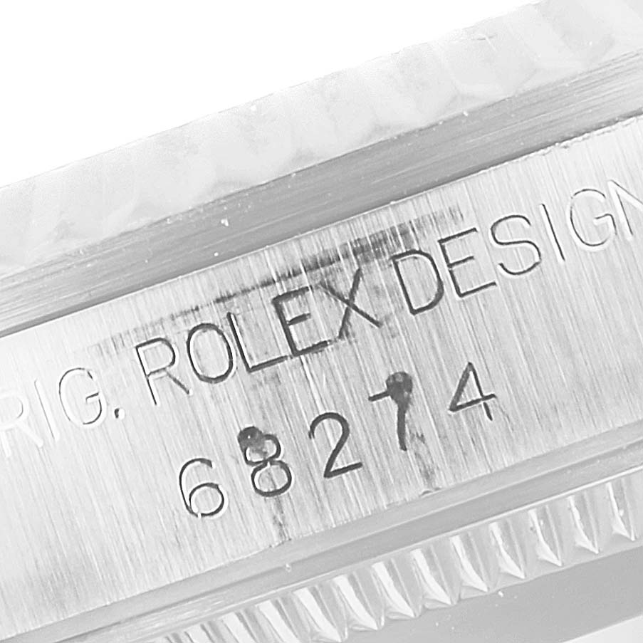 This close-up image shows the serial number and "ROLEX DESIGN" engraving on the side of a Mid-Size Rolex watch case.