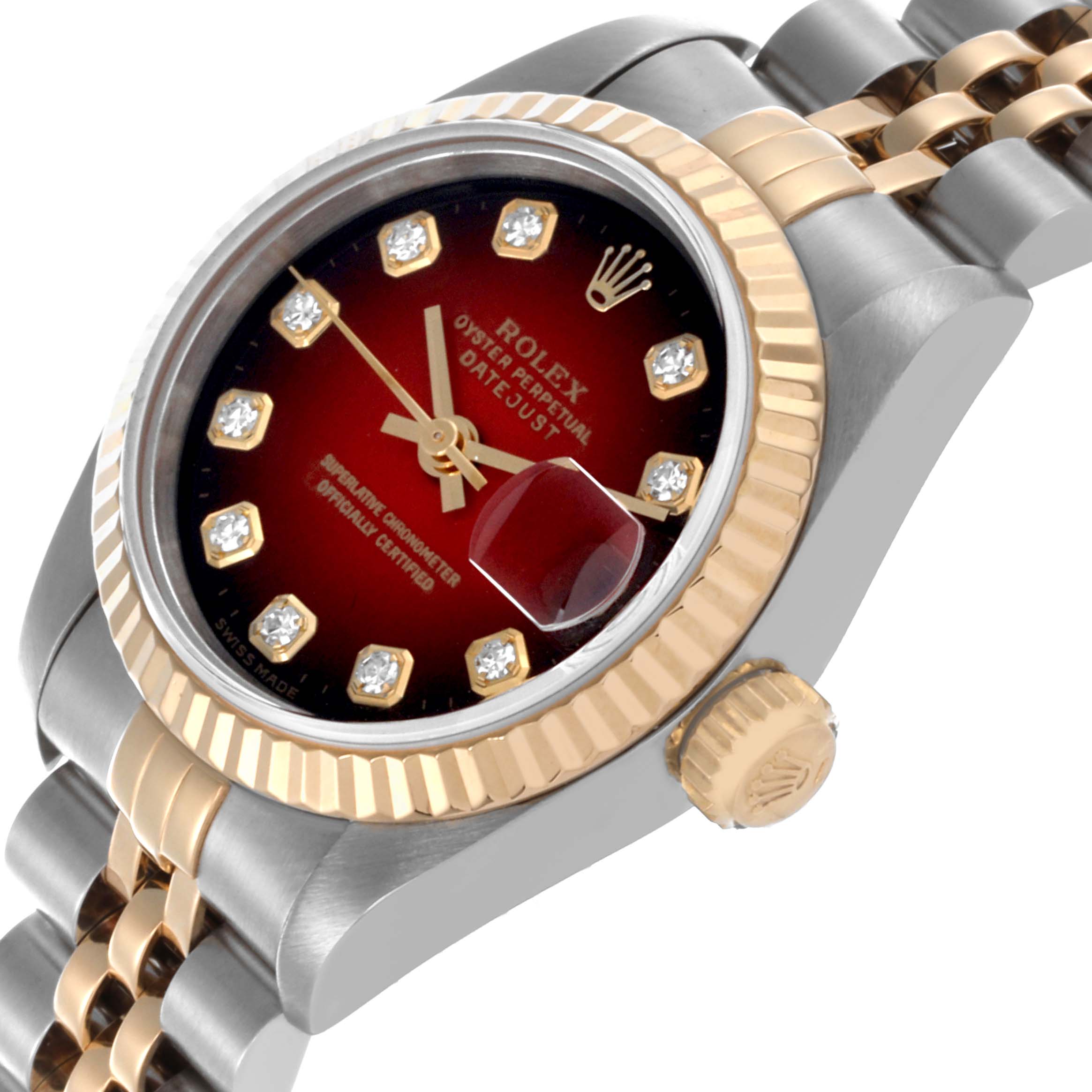 The Rolex Datejust 69173 Women's Steel and Gold (two tone) Red Dial 69173 Women's Steel and Gold (two tone) Red Dial watch is shown at an angled close-up highlighting the bezel, dial, and part of the two-tone bracelet.