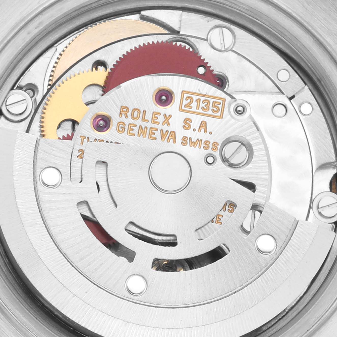The image shows the movement mechanism of the Rolex Datejust 69173 Women's Steel and Gold (two tone) Red Dial 69173 Women's Steel and Gold (two tone) Red Dial, highlighting gears and engravings.