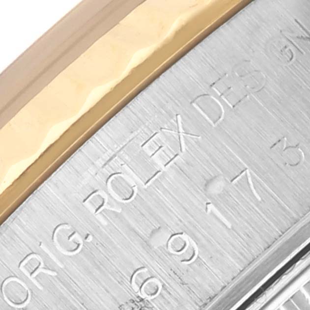 The image shows a close-up of the bezel and engraving on a Rolex Datejust 69173 Women's Steel and Gold (two tone) Red Dial 69173 Women's Steel and Gold (two tone) Red Dial watch.
