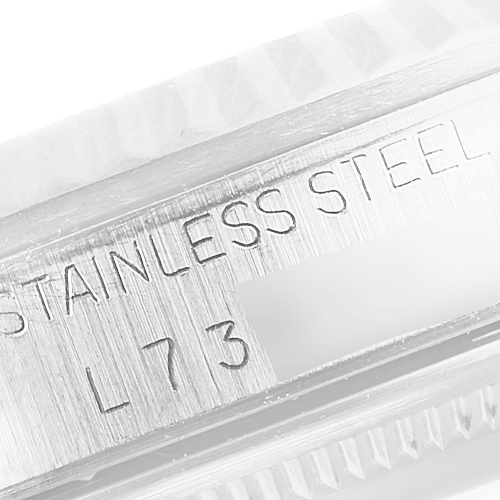 This image shows a close-up of the stainless steel case side of a Rolex Datejust 16234 Men's Stainless Steel Silver Dial 16234 Men's Stainless Steel Silver Dial watch, including some engraved text.