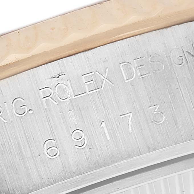 The image shows the engraved side view of a Rolex Datejust 69173 Women's Steel and Gold (two tone) Grey Dial 69173 Women's Steel and Gold (two tone) Grey Dial watch case, highlighting the serial number.