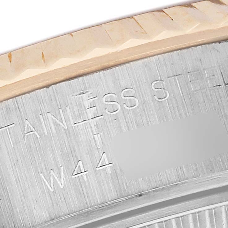 The image shows a close-up of the engraved edge on a Rolex Datejust 69173 Women's Steel and Gold (two tone) Grey Dial 69173 Women's Steel and Gold (two tone) Grey Dial, highlighting the stainless steel portion.
