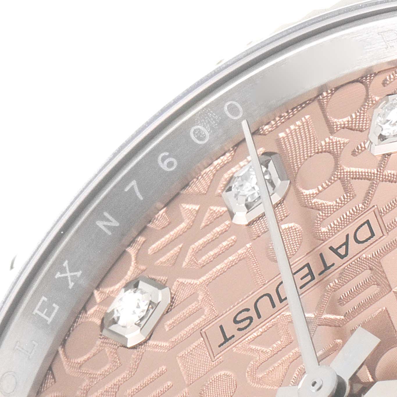 This close-up image of a Rolex Datejust 126234 Men
s Stainless Steel Pink Dial 126234 Men
s Stainless Steel Pink Dial watch shows a portion of the dial and part of the bezel, along with diamond-studded hour markers.