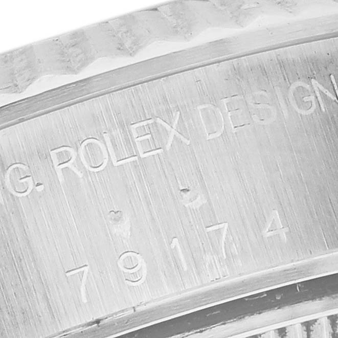 The image shows an angled close-up of the Rolex Datejust 79174 Women's Stainless Steel White Dial 79174 Women's Stainless Steel White Dial's engraved side, highlighting the "Rolex Design" text.