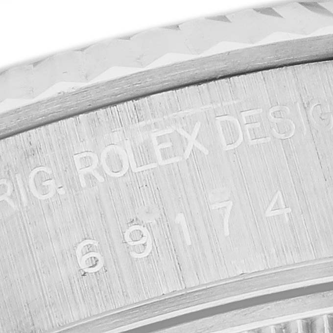The image shows a close-up of the side engraving on a Rolex Datejust 69174 Women's Stainless Steel White Dial 69174 Women's Stainless Steel White Dial watch case.