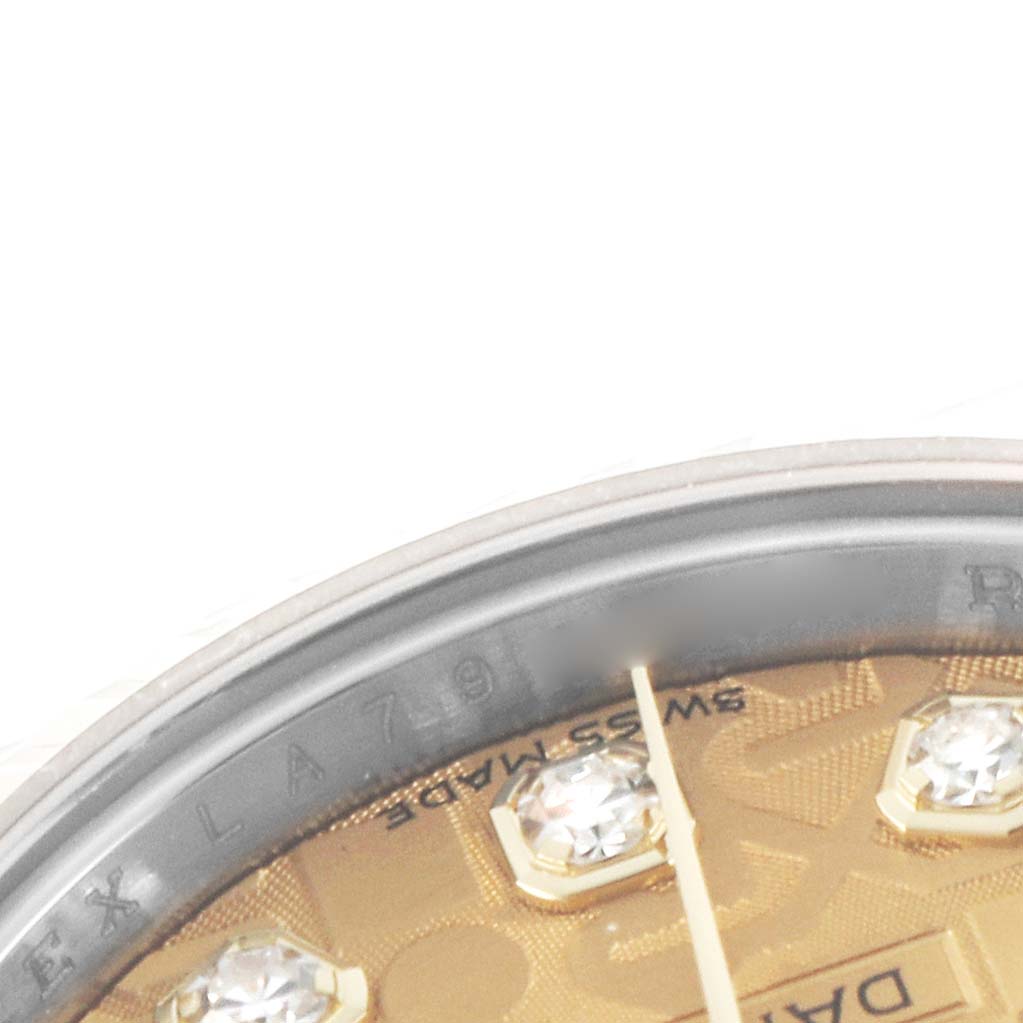 The image shows a close-up of the Rolex Datejust 179173 Women's Steel and Gold (two tone) Champagne Dial's dial with diamond markers, text, and part of the bezel from an angled view.