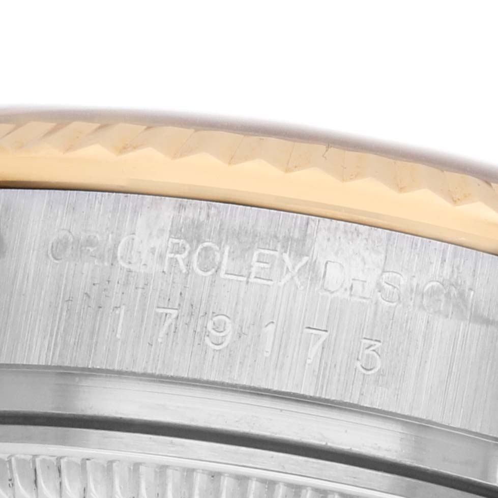 The image shows a close-up of the Rolex Datejust 179173 Women's Steel and Gold (two tone) Champagne Dial bezel and case side, highlighting the "ORIG. ROLEX DESIGN" engraving.