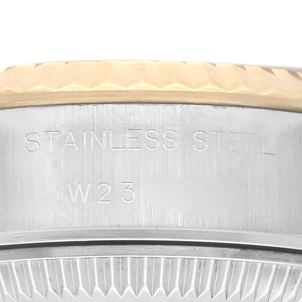 The image shows a close-up of the side of a Rolex Datejust 69173 Women
s Steel and Gold (two tone) Champagne Dial 69173 Women
s Steel and Gold (two tone) Champagne Dial, highlighting the stainless steel material and bezel detail.