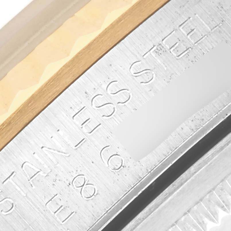 The image shows a close-up of the Rolex Datejust 16233 Men's Steel and Gold (two tone) Beige Dial 16233 Men's Steel and Gold (two tone) Beige Dial's case back engraving and metal edge details.